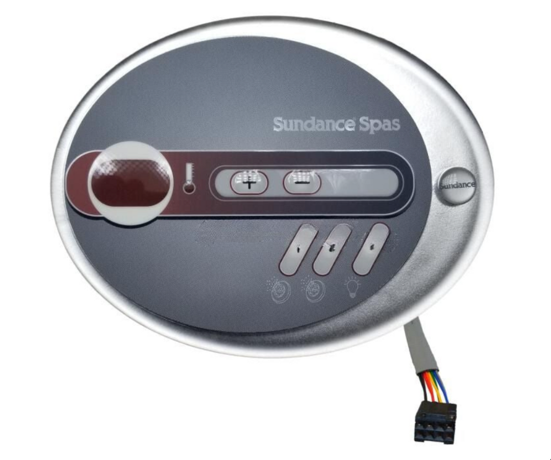 Sundance Spas oval control panel with a silver outer frame, dark gray faceplate, control buttons, and a small multicolor wiring connector extending from the bottom right. Sundance® 680 Series 2‑Pump SMT Control Board – 60 Hz (2013+) Part 