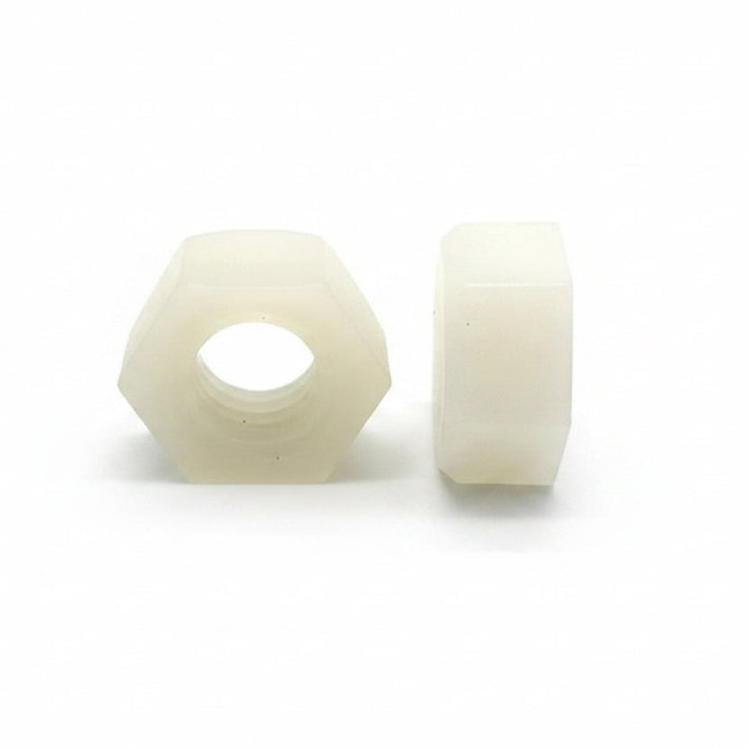 Two white hexagonal nuts on a white background