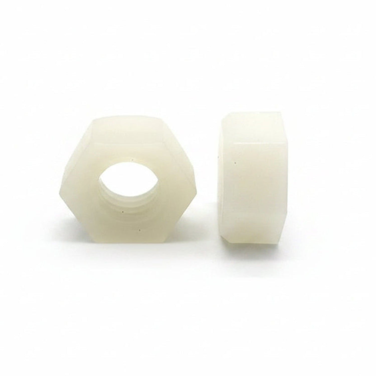 Two white hexagonal nuts on a white background