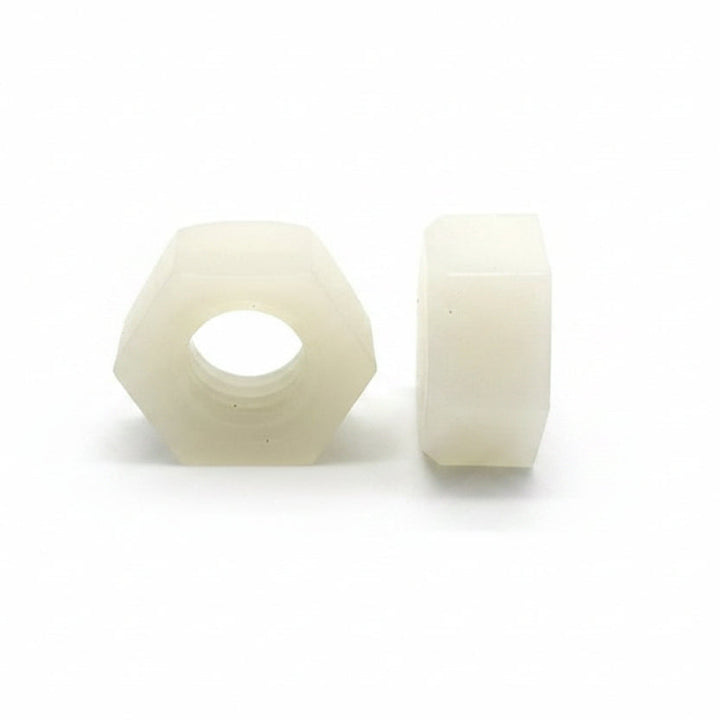 Two white hexagonal nuts on a white background